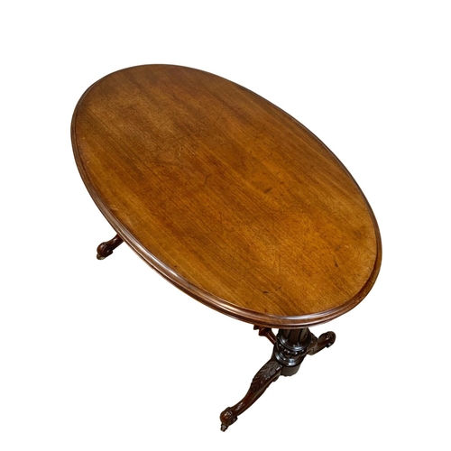 1068 - A Victorian mahogany library table on carved double pedestal base, 105cm x 65 x 75cm