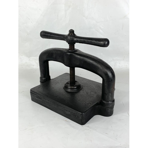 347 - A large cast iron book press.  40x34cm