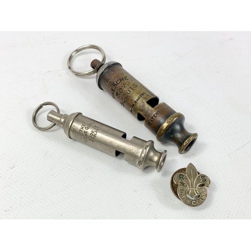 388 - An early 20th century Boy Scout whistle and badge with other whistle