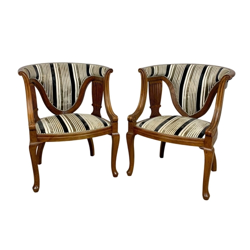 1101 - A pair of Edwardian mahogany tub armchairs