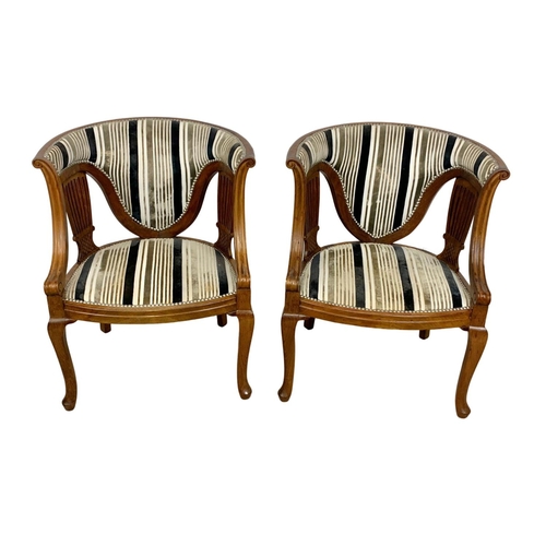 1101 - A pair of Edwardian mahogany tub armchairs