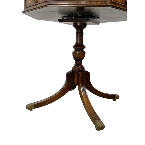 1118 - A mahogany revolving drum table with a leather top in the Georgian style.  61x66cm