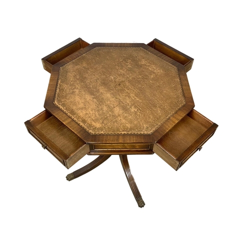 1118 - A mahogany revolving drum table with a leather top in the Georgian style.  61x66cm