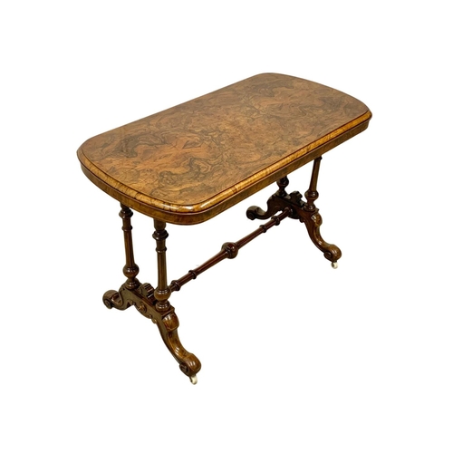 1121 - A Victorian inlaid Burr Walnut library table with stretcher support. 106 x 55 x 74cm.