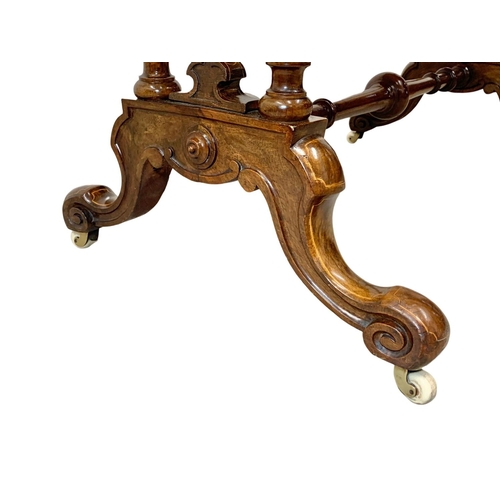 1121 - A Victorian inlaid Burr Walnut library table with stretcher support. 106 x 55 x 74cm.