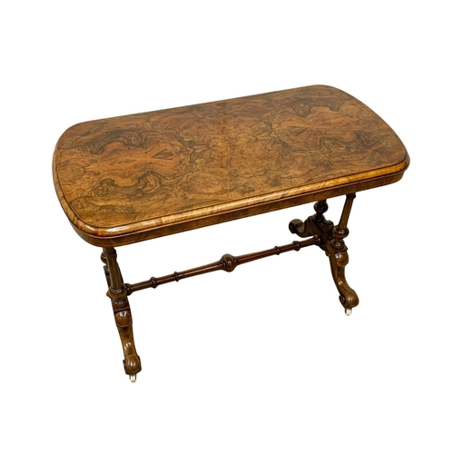 1121 - A Victorian inlaid Burr Walnut library table with stretcher support. 106 x 55 x 74cm.