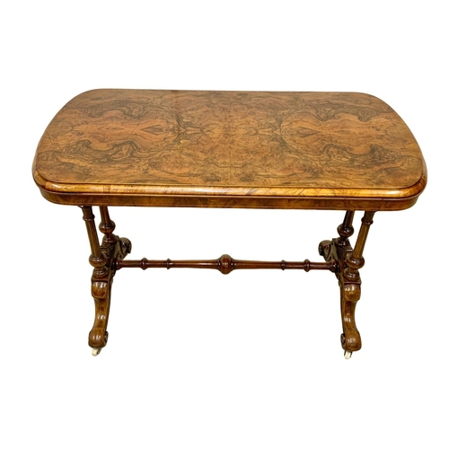 1121 - A Victorian inlaid Burr Walnut library table with stretcher support. 106 x 55 x 74cm.