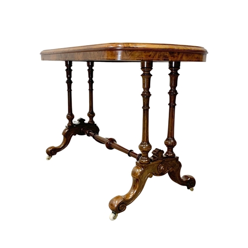 1121 - A Victorian inlaid Burr Walnut library table with stretcher support. 106 x 55 x 74cm.