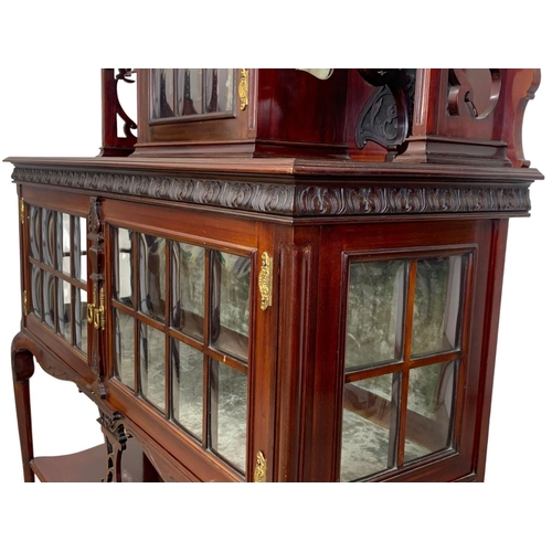 1001 - An Edwardian ornate mahogany display cabinet with fretwork carving. 116.5 x 41.5 x 209cm.