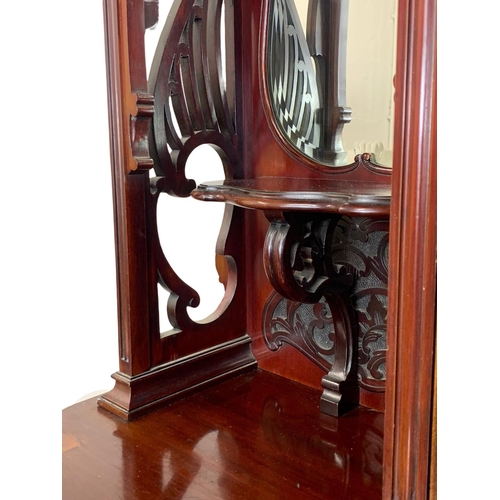 1001 - An Edwardian ornate mahogany display cabinet with fretwork carving. 116.5 x 41.5 x 209cm.