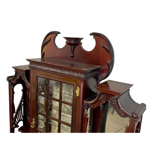 1001 - An Edwardian ornate mahogany display cabinet with fretwork carving. 116.5 x 41.5 x 209cm.