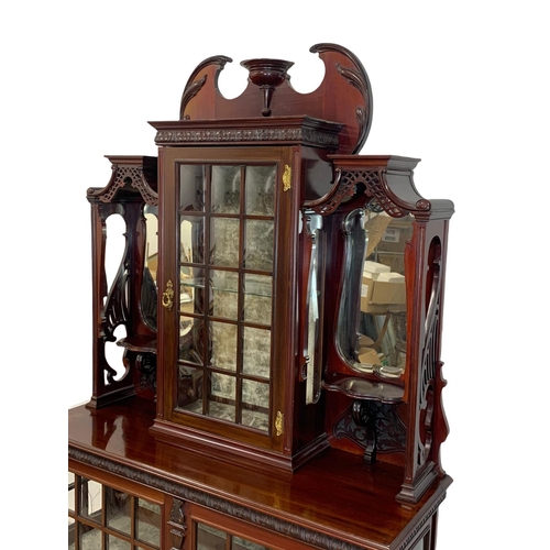 1001 - An Edwardian ornate mahogany display cabinet with fretwork carving. 116.5 x 41.5 x 209cm.