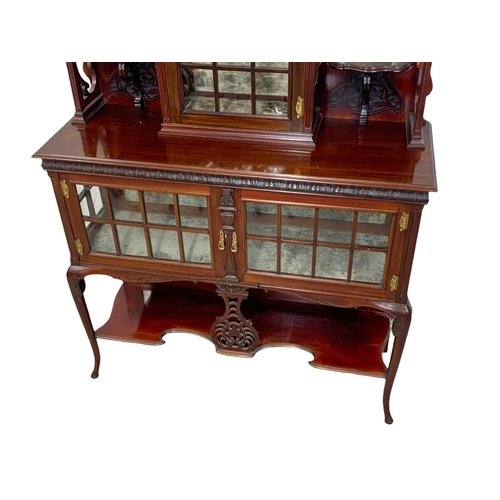 1001 - An Edwardian ornate mahogany display cabinet with fretwork carving. 116.5 x 41.5 x 209cm.