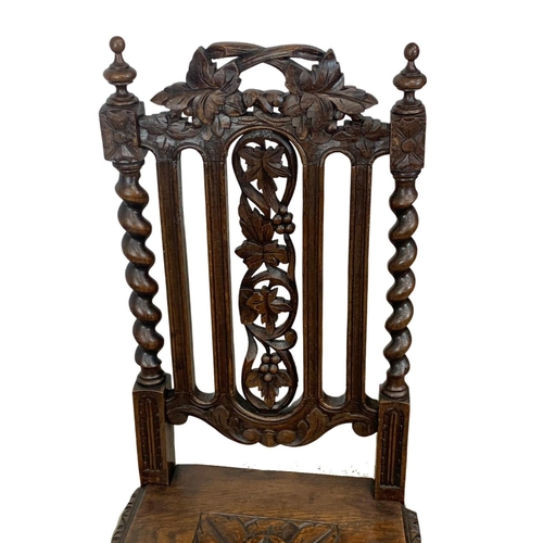 1002 - A Victorian carved oak hall chair. Circa 1870.