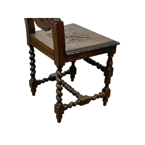 1002 - A Victorian carved oak hall chair. Circa 1870.