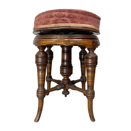 1003 - A Victorian walnut revolving piano stool.