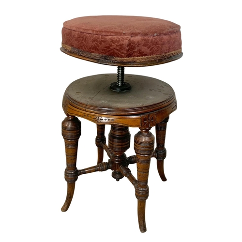 1003 - A Victorian walnut revolving piano stool.