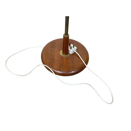 1007 - A teak and brass Mid Century standard lamp. 141cm.