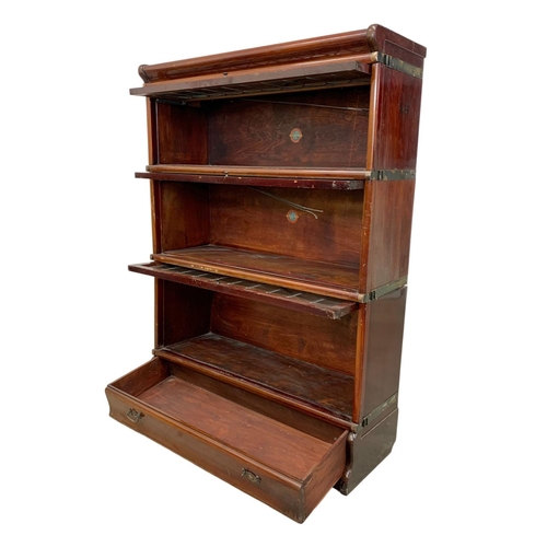 1015 - An early 20th century Globe Wernicke mahogany stacking bookcase. Circa 1910-1920. 86.5 x 31.5 x 120.... 