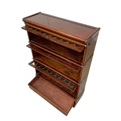 1015 - An early 20th century Globe Wernicke mahogany stacking bookcase. Circa 1910-1920. 86.5 x 31.5 x 120.... 