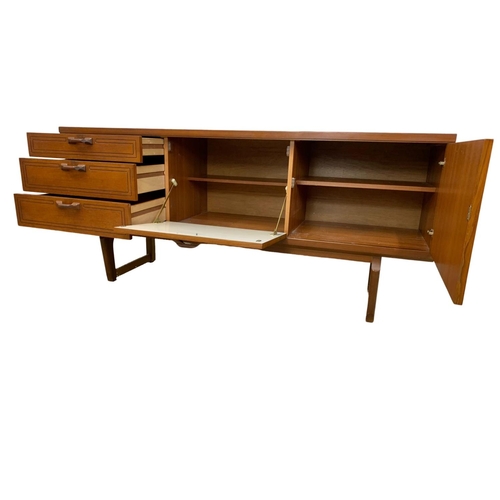 1016 - A teak sideboard with 3 drawers and cocktail cupboard. Mid Century. 1970.  161 x 45.5 x 72.5cm