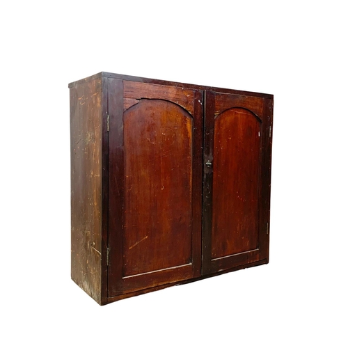 1034 - A Victorian pine 2 door cupboard with 2 drawers and 2 shelves. Circa 1870-1880. 86.5 x 32.5 x 81.5cm