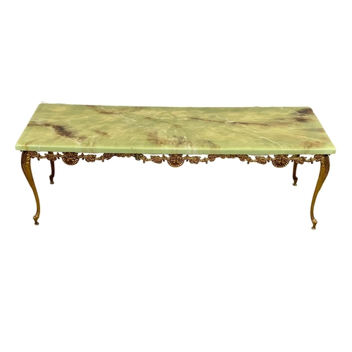 1047 - n ornate brass and faux onyx coffee table. 121.5 x 40 x 40cm.