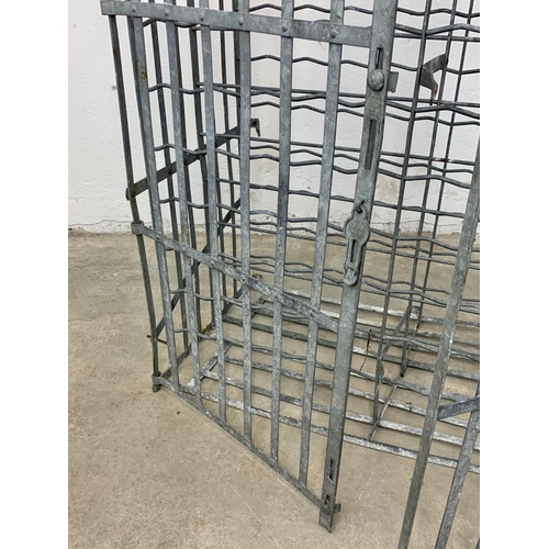 1048 - A large vintage industrial metal double door wine rack. 102 x 55.5 x 162cm.