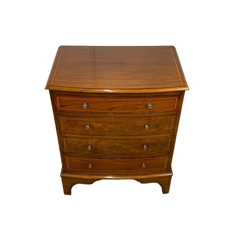 1049 - An Edwardian period inlaid mahogany bow front chest of drawers in the Georgian style. 68 x 45 x 82cm... 