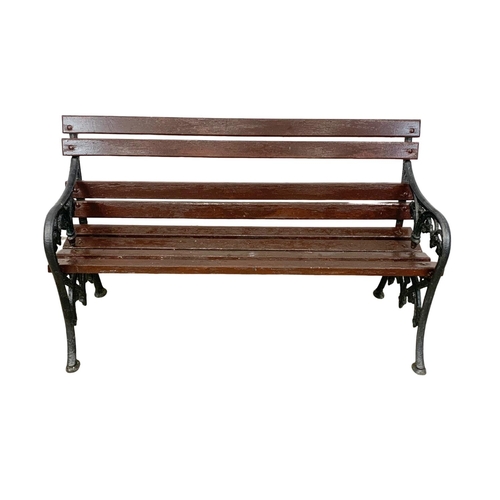 1051 - An early 20th century cast iron garden bench with wooden straps. 138cm