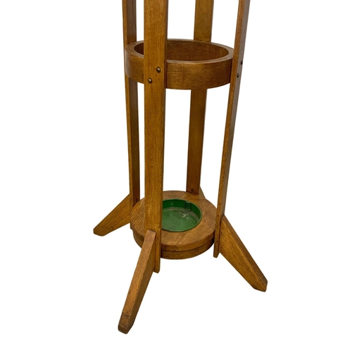 1056 - An early 20th century oak hat and coat stand with revolving top. 198cm.