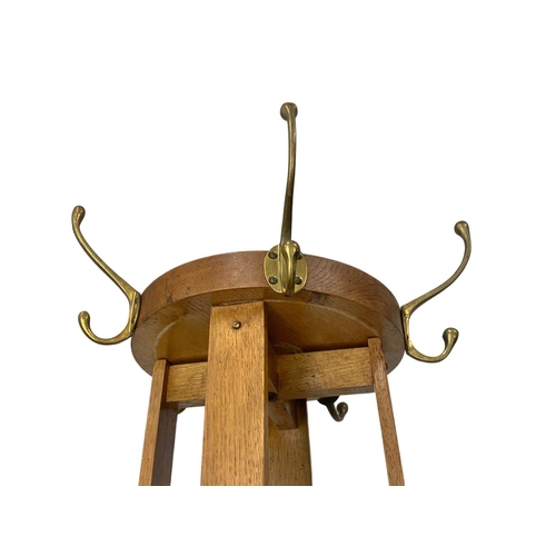 1056 - An early 20th century oak hat and coat stand with revolving top. 198cm.