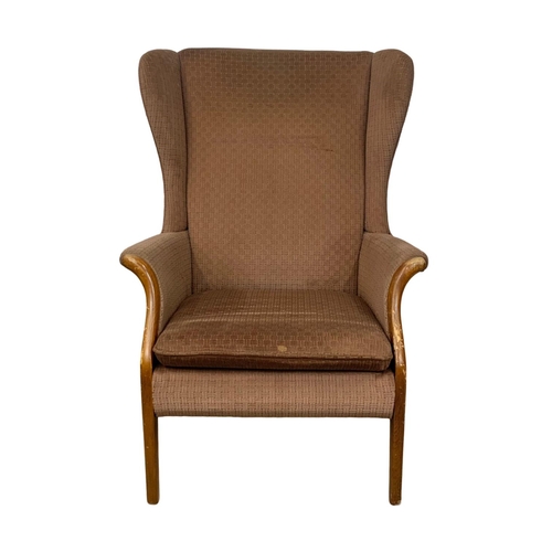 1058 - A vintage Parker Knoll wingback armchair.