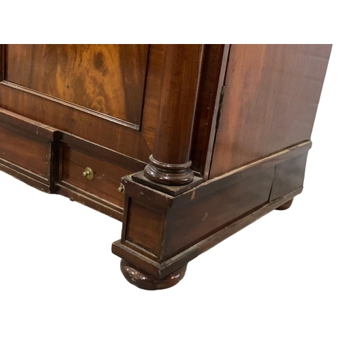 1070 - A large Victorian mahogany combination bookcase and linen cabinet. Circa 1850