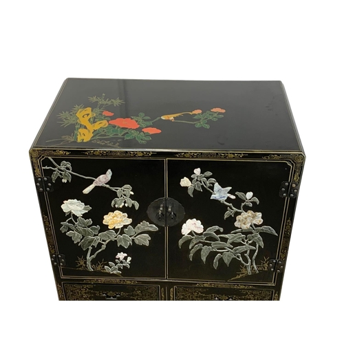 1084 - A large Chinese lacquered cabinet with 2 drawers. 96.5 x 55.5 x 138cm.