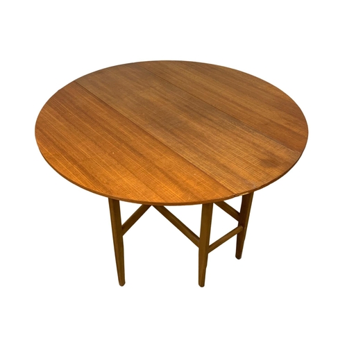 1089 - A Mid Century teak and beech drop leaf dining table and 4 chairs. Extended 120 x 74cm