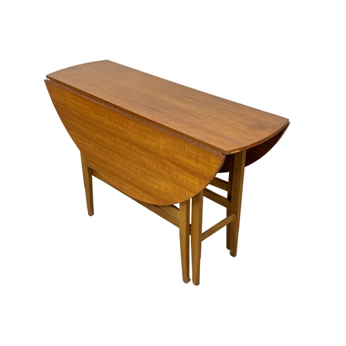 1089 - A Mid Century teak and beech drop leaf dining table and 4 chairs. Extended 120 x 74cm