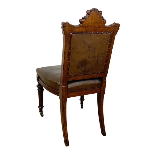 1091 - A late Victorian carved oak side chair with original leather back and seat. In the Neo Gothic style ... 