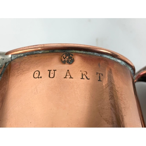 11 - A good quality Victorian copper jug. V.R. Quart. 18 x 16cm.