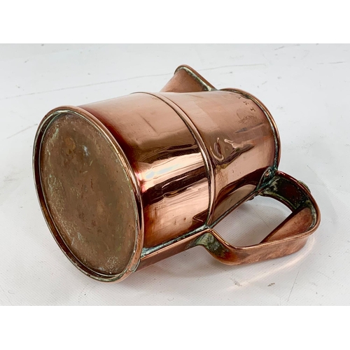 11 - A good quality Victorian copper jug. V.R. Quart. 18 x 16cm.