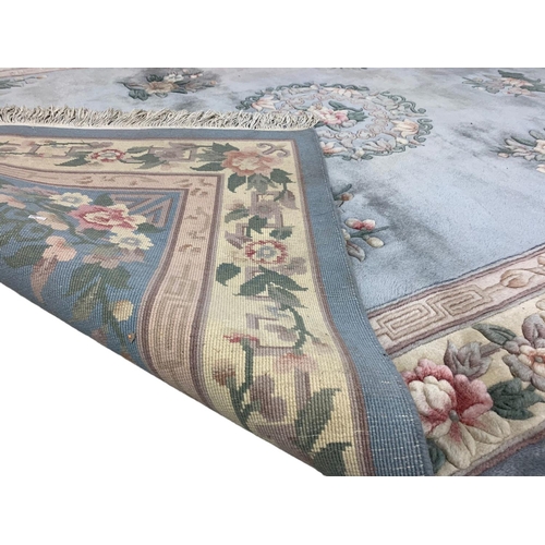 1113 - A large Chinese wool rug 183 x 300cm