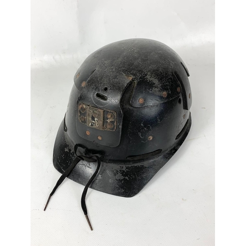 112 - A vintage miners helmet and a miners Oxygen Self Rescue Device.