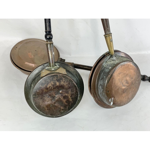 118 - 3 Victorian copper bed pans. Largest measures 116cm.