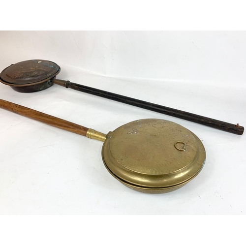 119 - A Victorian copper bed pan and a vintage brass bed pan. Largest 106cm