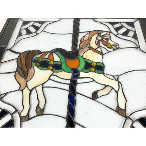 129 - An ornate stained glass panel. 61 x 64cm