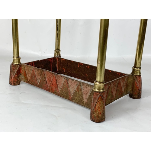 130 - A Victorian brass and cast iron umbrella stick stand. 31 x 20 x 62cm