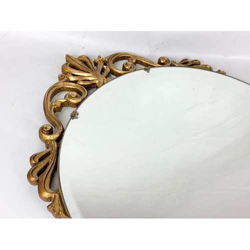 131 - A vintage ornate gilt framed bevelled mirror. 45 x 83cm.