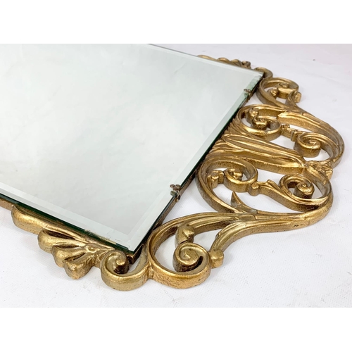 131 - A vintage ornate gilt framed bevelled mirror. 45 x 83cm.