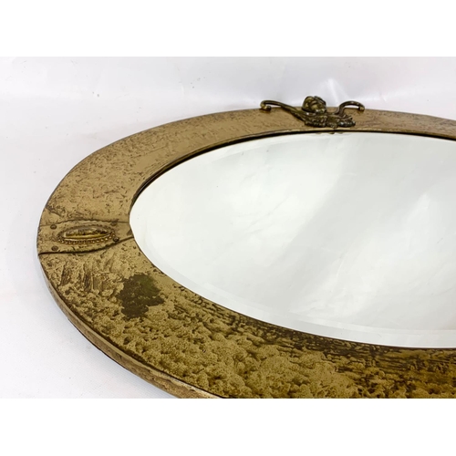 141 - An early 20th century Arts & Crafts brass framed mirror. Circa 1900-1910. 82 x 54cm.