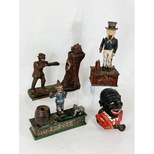 150 - 4 old style cast iron money boxes. Largest 29cm.